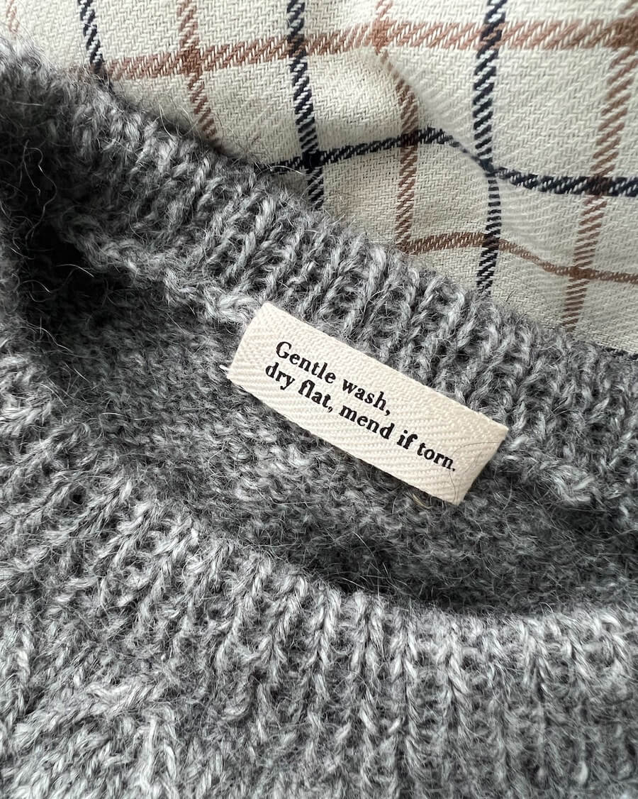 "Gentle wash, dry flat, mend if torn." label by Petiteknit