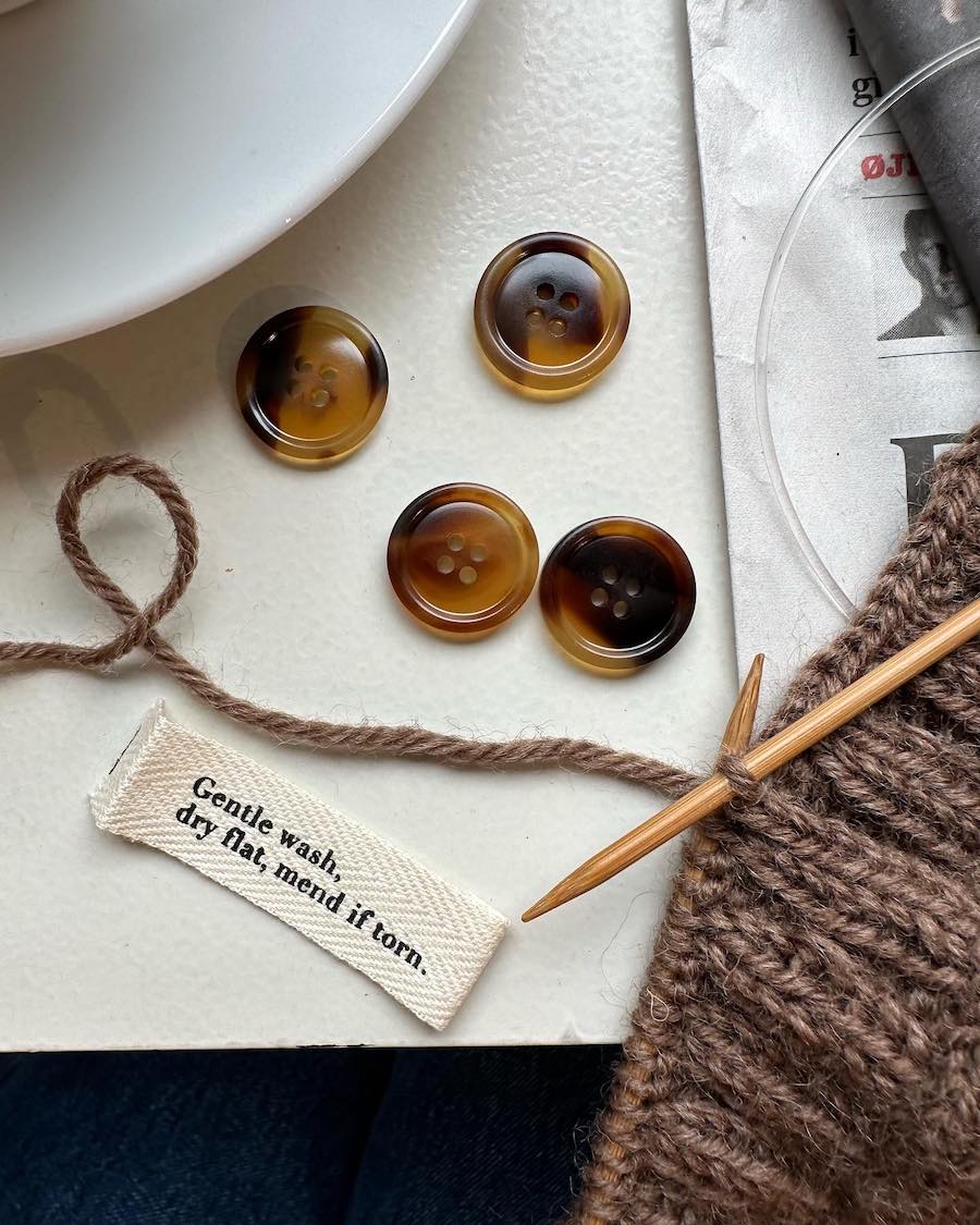 "Gentle wash, dry flat, mend if torn." label by Petiteknit